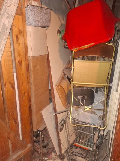Cellier encombré de mobilier pliant et de matériel divers